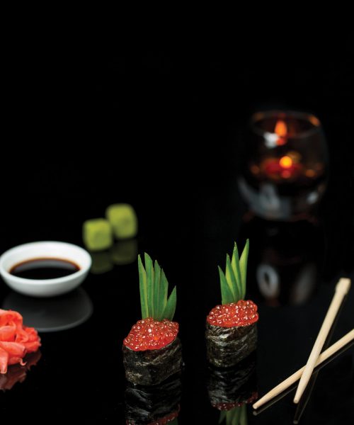 sushi rolls with red salmon caviar sauce
